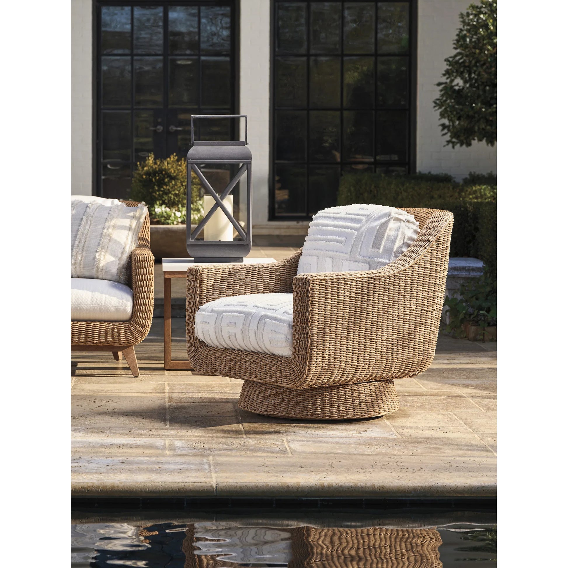 Isle of Palms Swivel Lounge Chair by Tommy Bahama Outdoor in white, ivory and brown. Made from teak, rattan, fabric in a unique style.