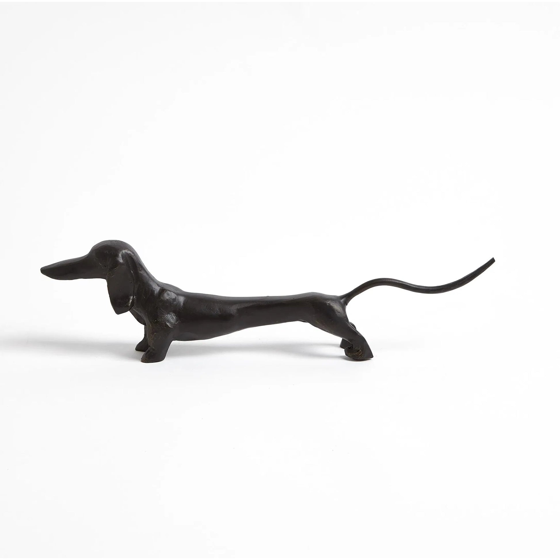 Dachshund Hound Sculpture by Global Views in bronze. Made from cast iron in a eclectic & global style.