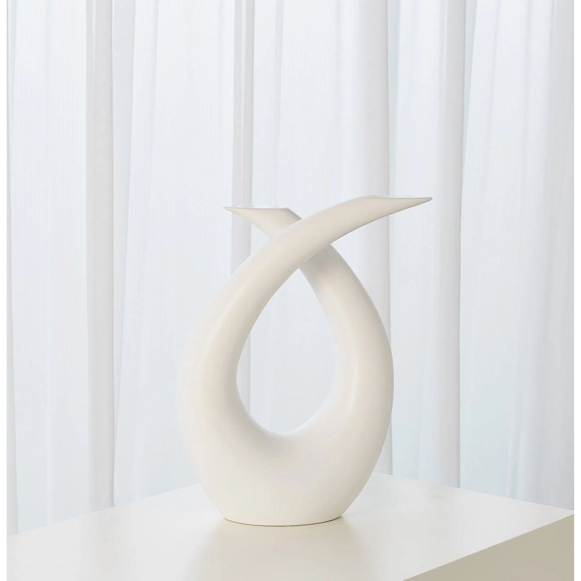 Loop Sculpture by Global Views. Made from ceramic in a modern style.