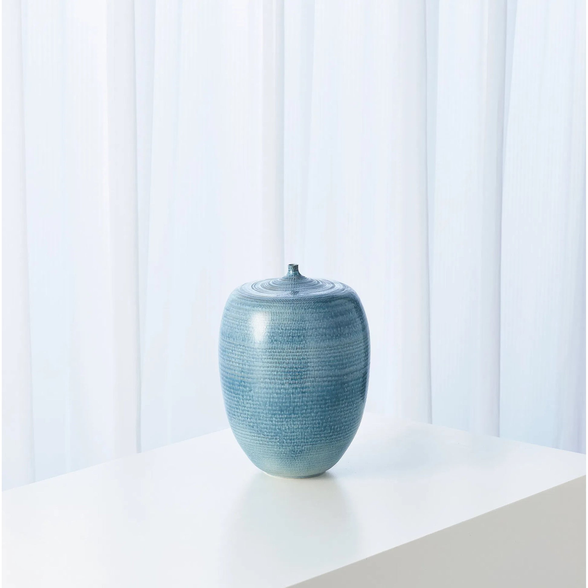 Fat Bottle by Global Views. Made from porcelain in a coastal style.