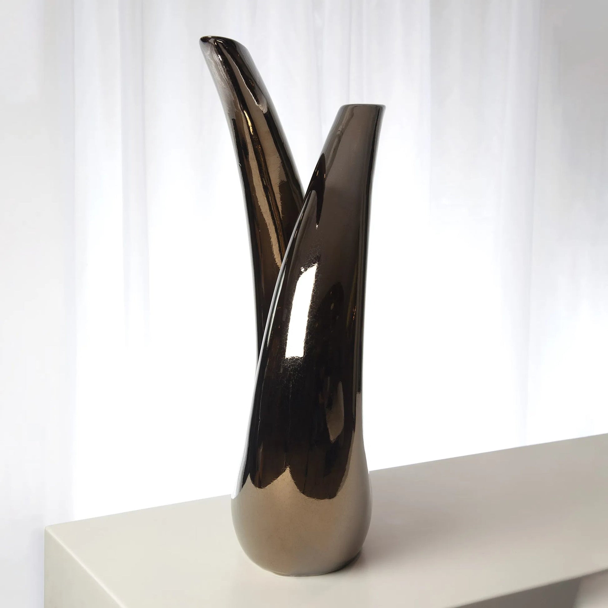 Loop Sculpture by Global Views. Made from ceramic in a modern style.
