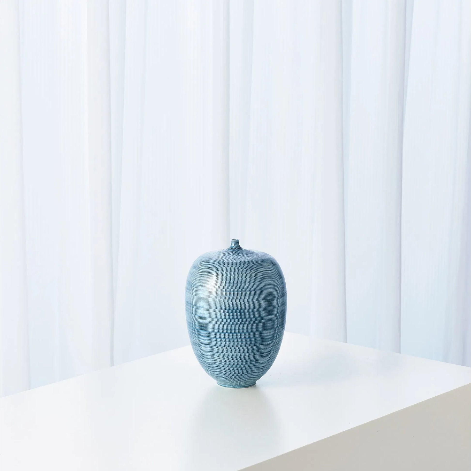 Fat Bottle by Global Views. Made from porcelain in a coastal style.