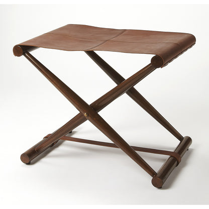 Sutton Leather Folding Stool by Butler Specialty Company in medium brown and butler loft. Made from natural leather, shorea, meranti wood solids in a rustic style.