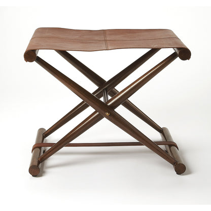 Sutton Leather Folding Stool by Butler Specialty Company in medium brown and butler loft. Made from natural leather, shorea, meranti wood solids in a rustic style.