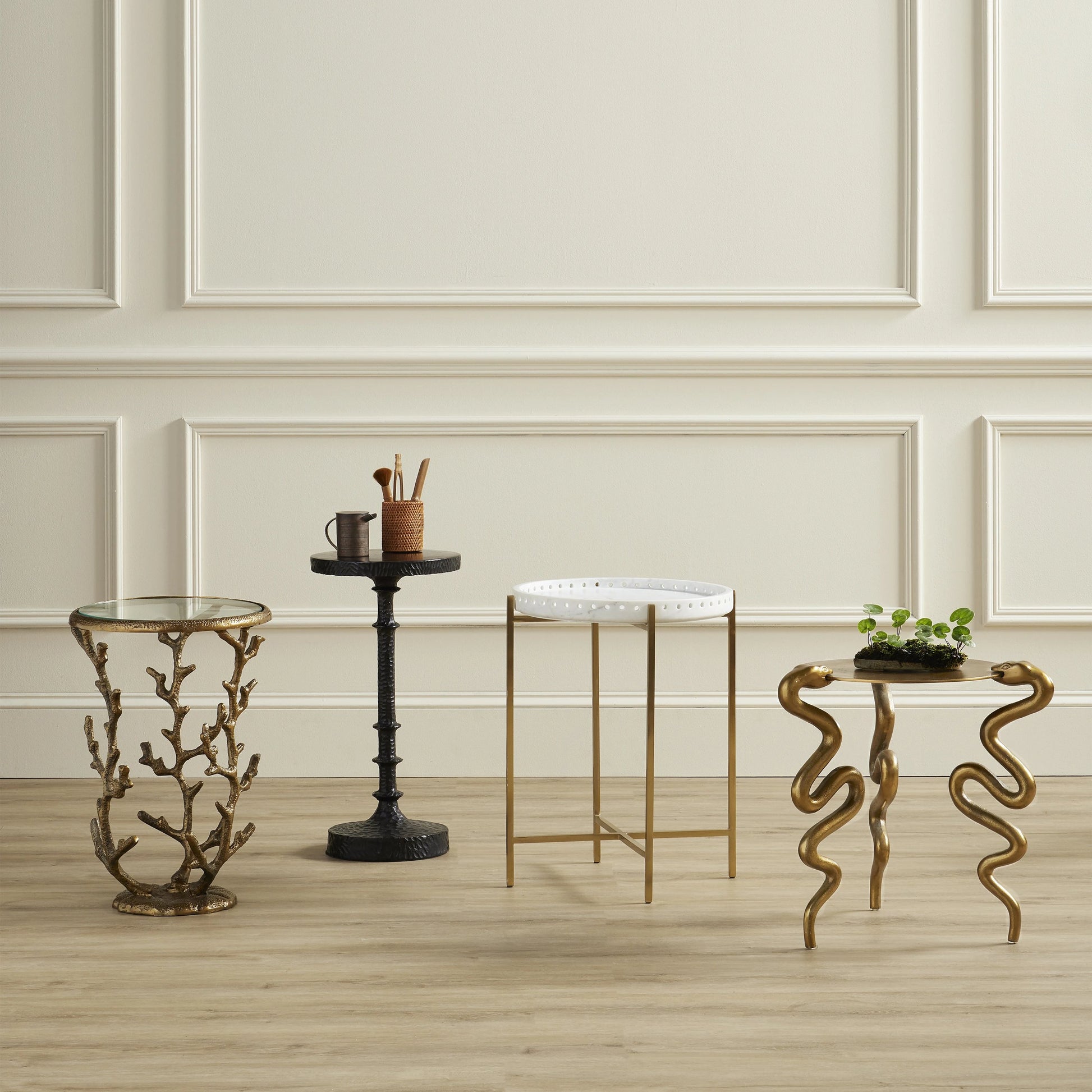 Serpent Accent Table by Currey and Company in antique brass. Made from cast aluminum in a modern style.