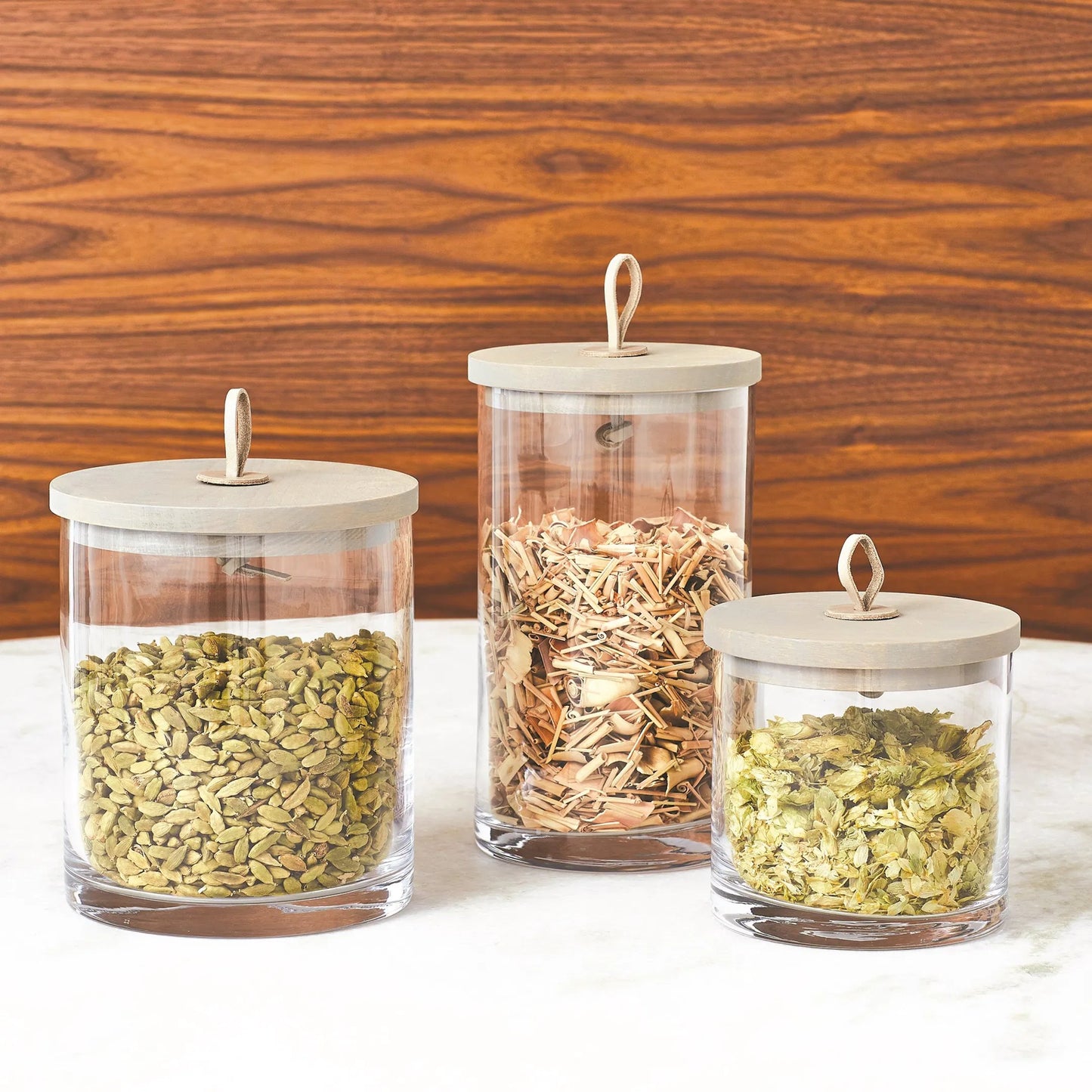 009 SR-702001,SR-702002,SR-702003 | Lifestyle | Rustic Canister by Global Views. Made from oak, glass, leather in a transitional style.