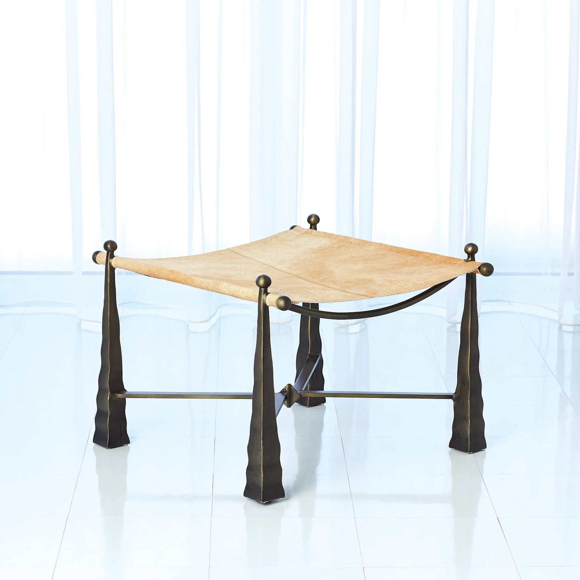 Cognac Ottoman by Global Views. Made from metal, cowhide in a rustic style.