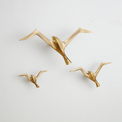Flock Wall Decor by Global Views. Made from brass in a coastal style.