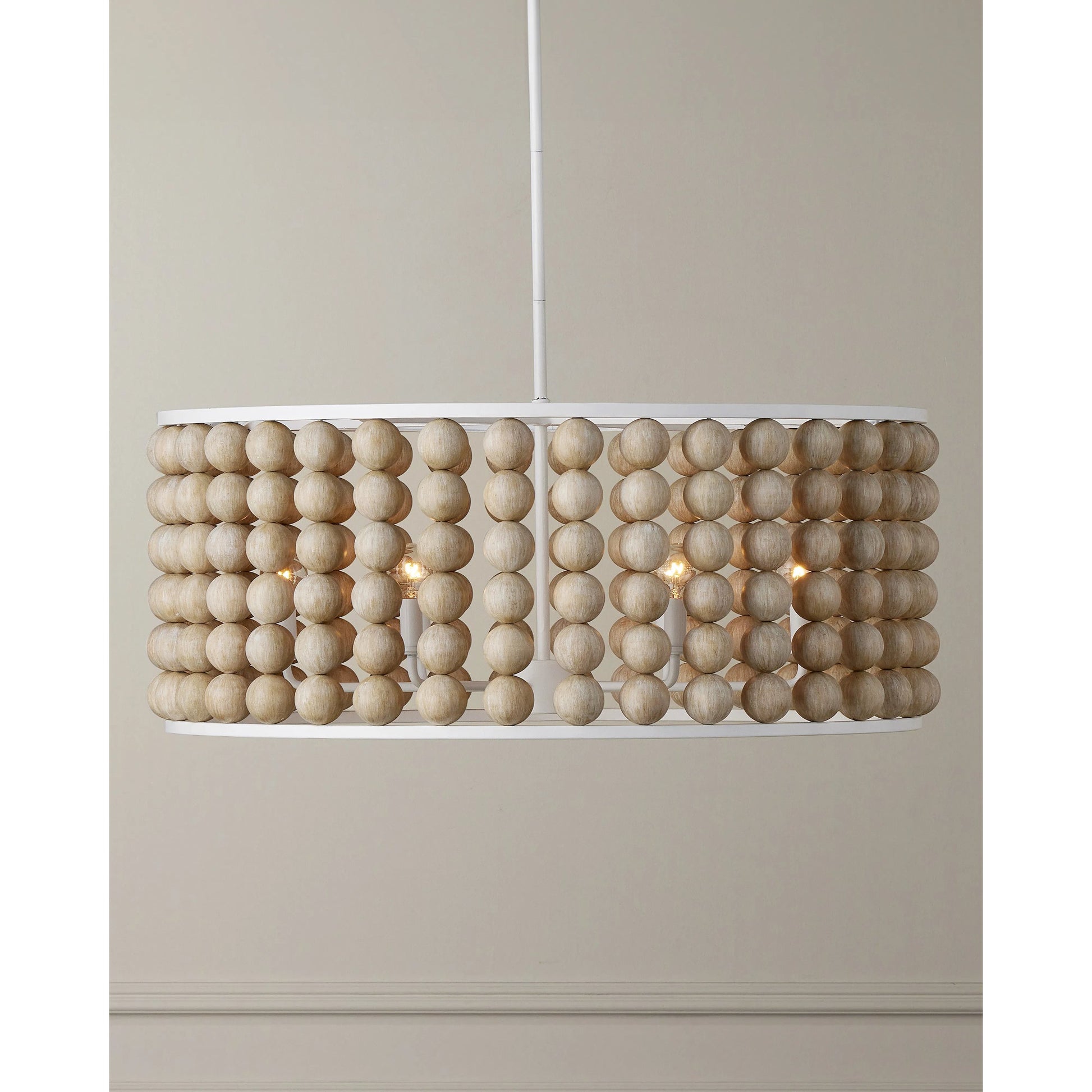 Holcroft Chandelier by Currey and Company in sandstone, sugar white. Made from wood beads, wrought iron in a modern style.