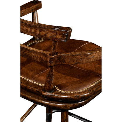 Casual Accents Tudor Oak Studded Leather Bar Stool by Jonathan Charles in brown and dark brown tudor oak. Made from oak in a rustic style.