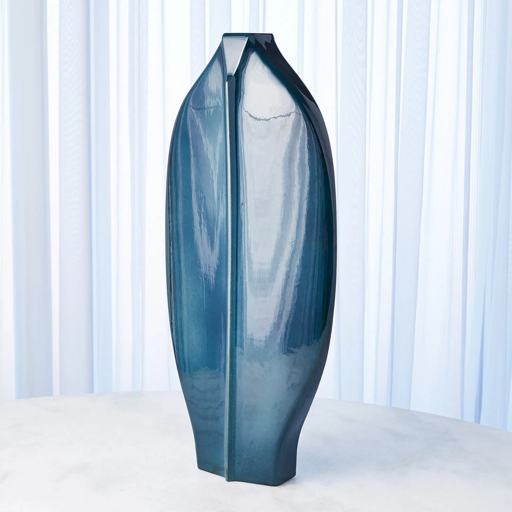 Center Ridge Vase by Global Views in blue. Made from earthenware-reactive glaze in a modern style.