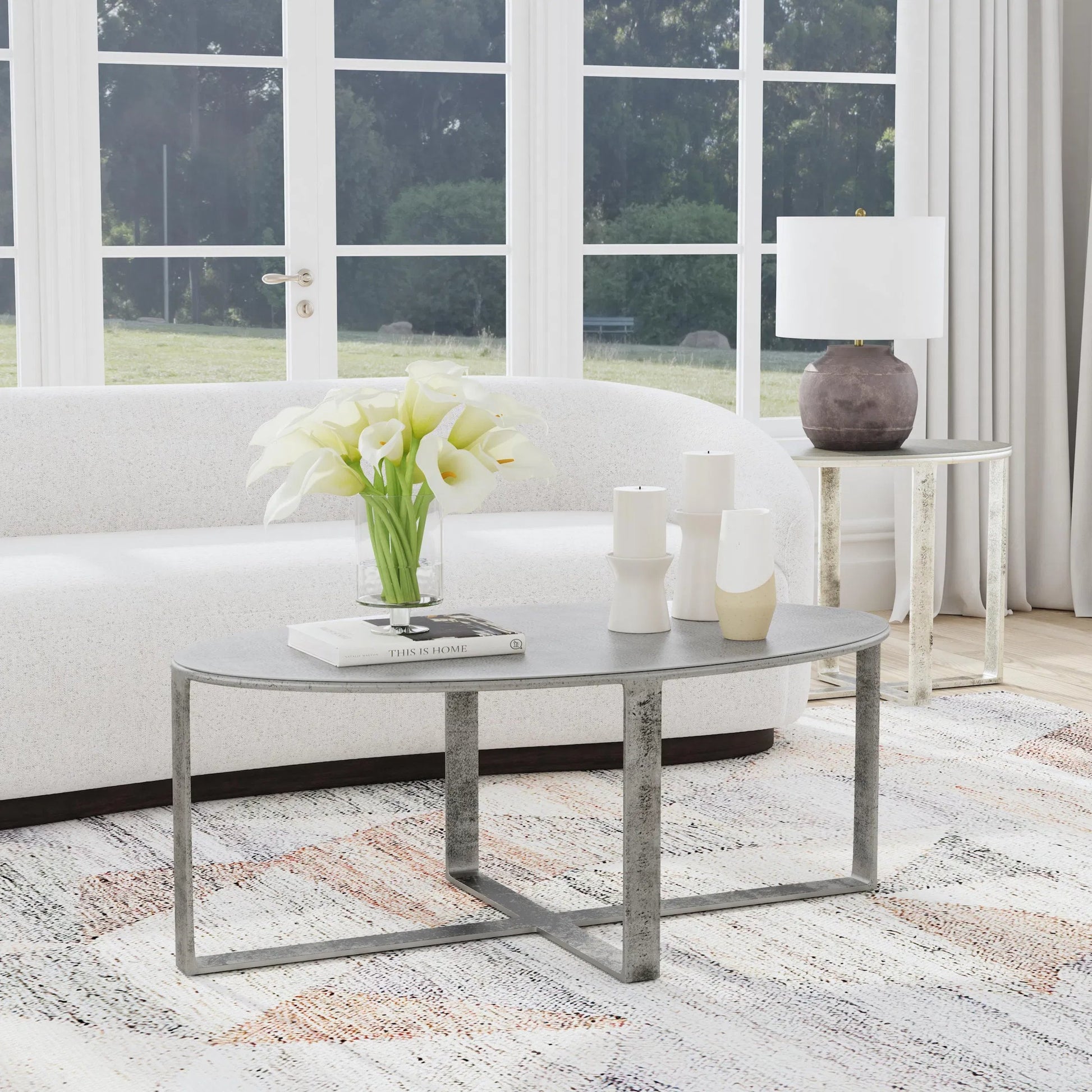 Flores 48" Oval Coffee Table by Classic Home in nickel. Made from cast aluminum in a unique style.