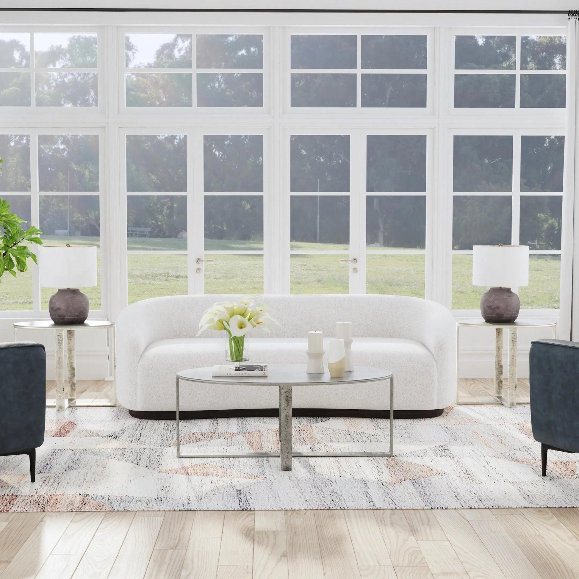 Flores 48" Oval Coffee Table by Classic Home in nickel. Made from cast aluminum in a unique style.