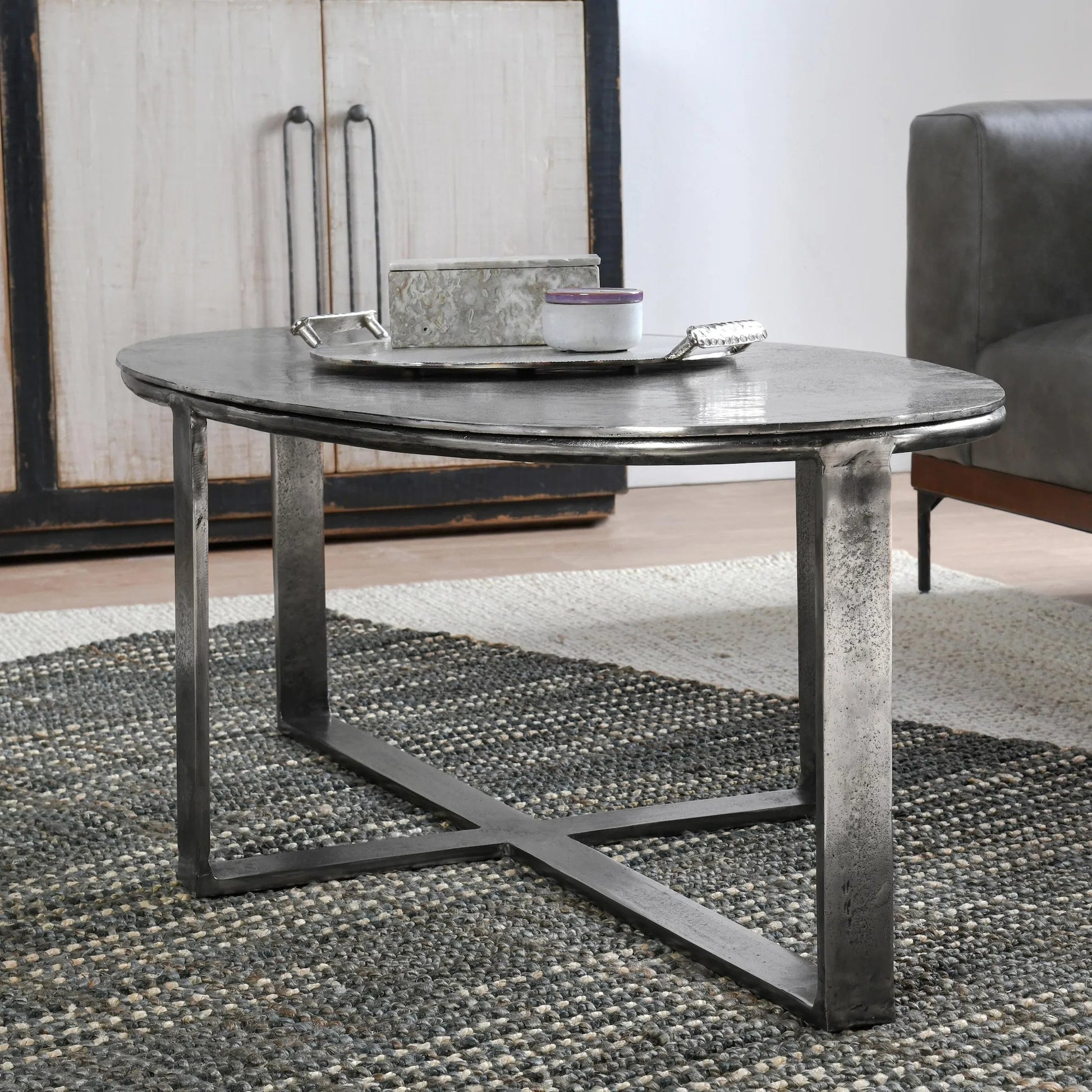 Flores 48" Oval Coffee Table by Classic Home in nickel. Made from cast aluminum in a unique style.