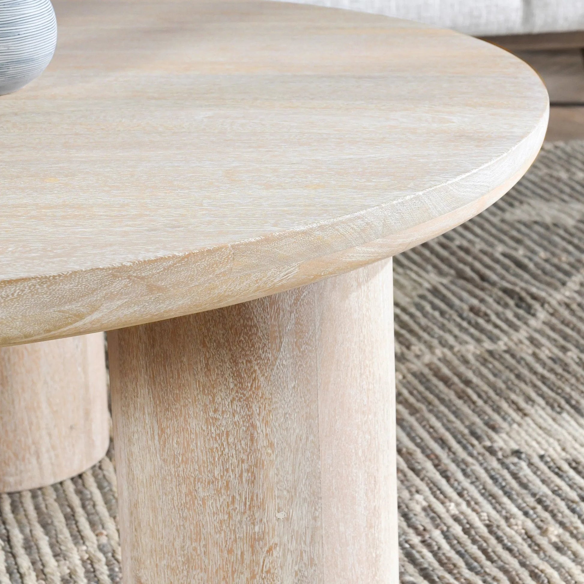 Beau Solid Wood Round Coffee Table by Kosas Home. Made from mango wood in a modern style.