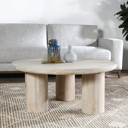 Beau Solid Wood Round Coffee Table by Kosas Home. Made from mango wood in a modern style.