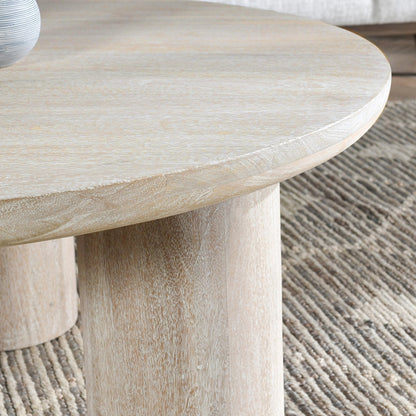 Beau Solid Wood Round Coffee Table by Kosas Home. Made from mango wood in a modern style.