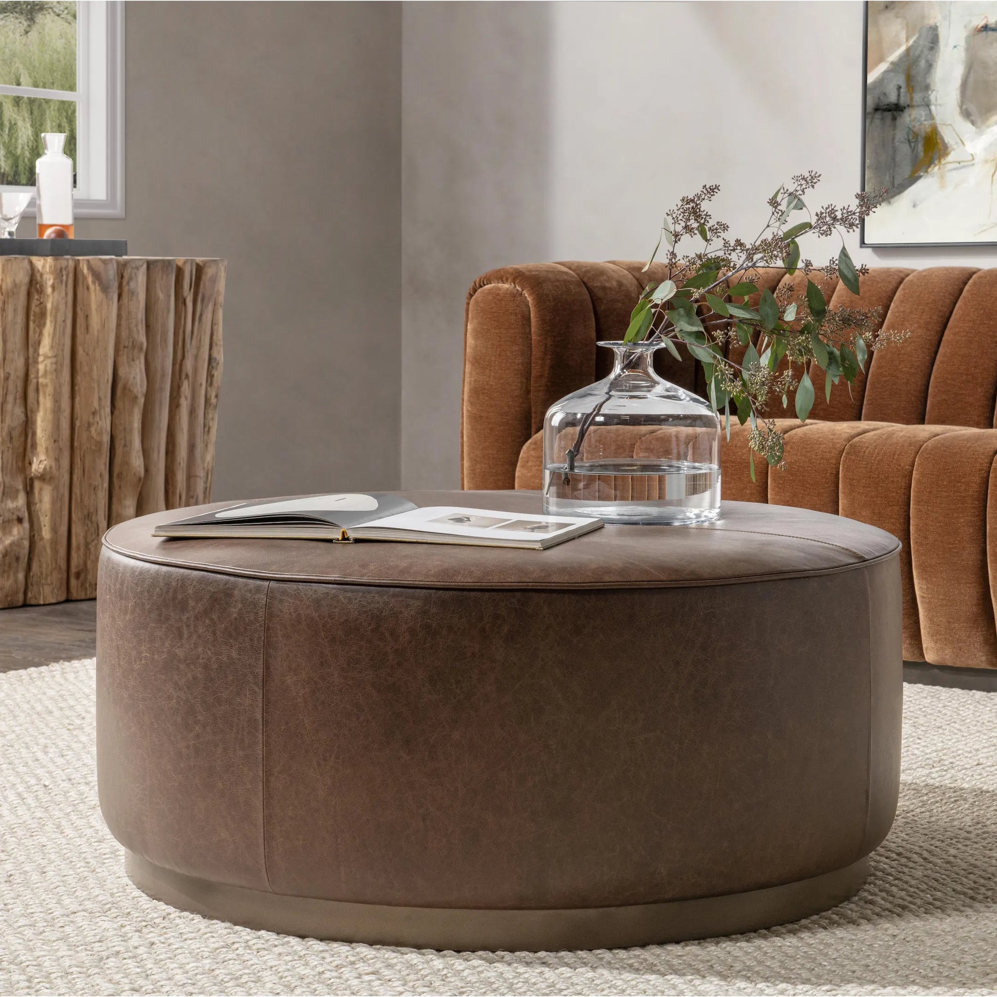 Clair Leather Round Coffee Table by Classic Home in brown, brass. Made from top grain leather in a unique style.