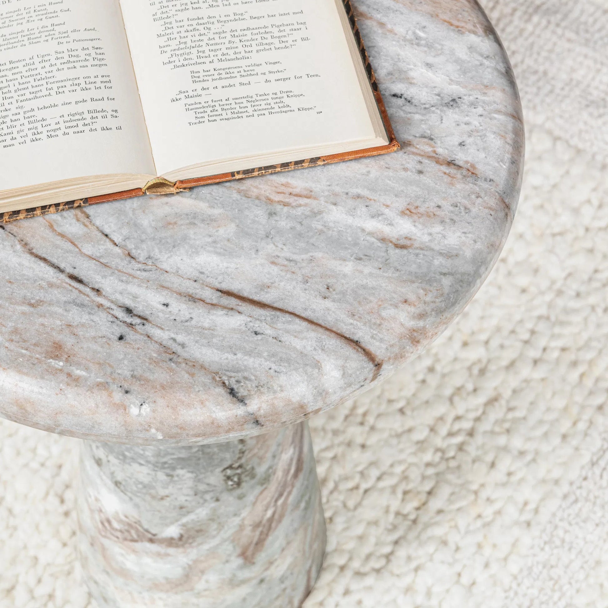 Huxley Round Accent Table by Classic Home in rusty gray. Made from marble in a unique style.