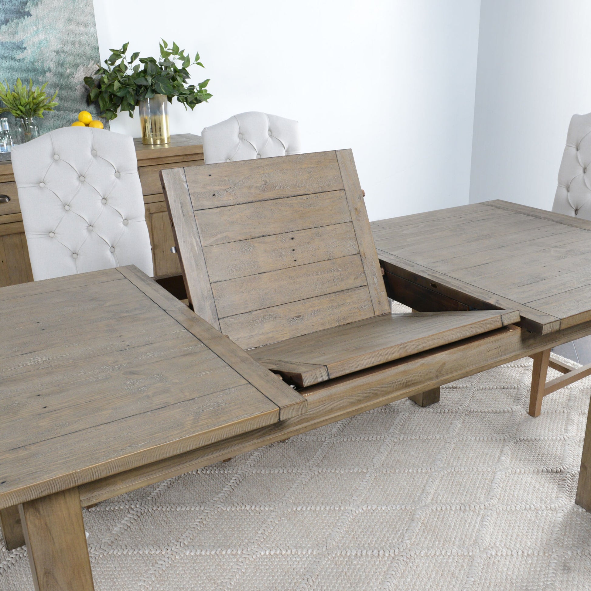 Driftwood Extension Dining Table by Kosas Home in desert gray. Made from reclaimed pine wood in a rustic style.