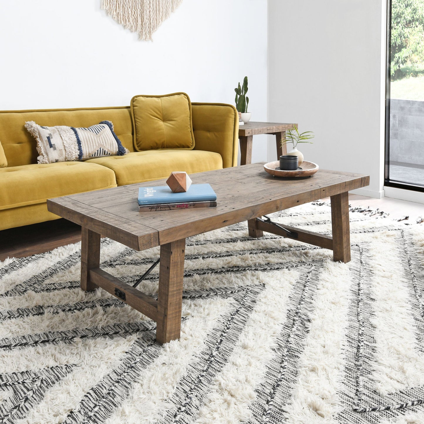 007 SR-897831 | Lifestyle | Tuscany Coffee Table by Kosas Home in weathered gray. Made from reclaimed pine wood in a rustic style.