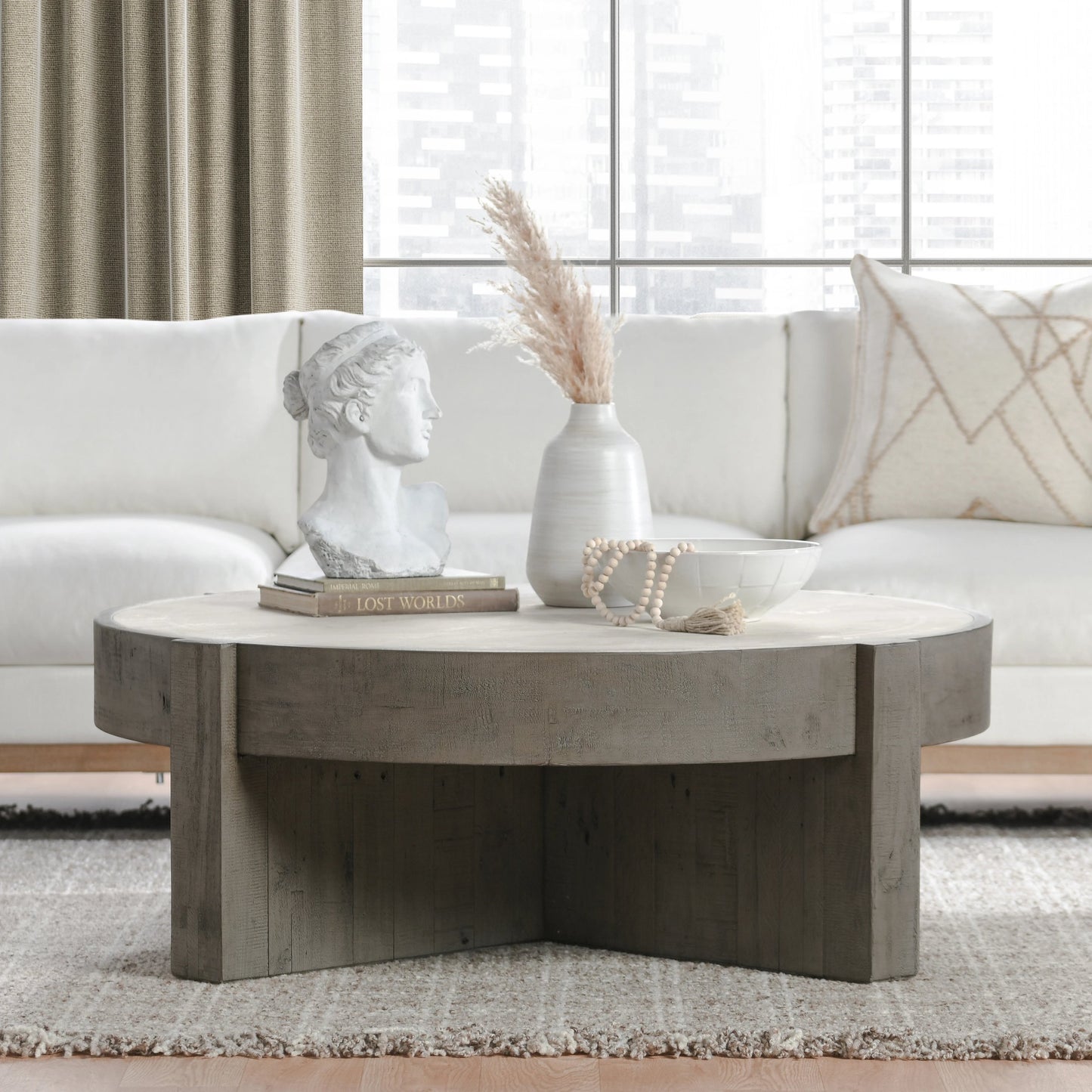 006 SI-2160261 | Lifestyle | Sonoma Round Reclaimed Pine Coffee Table by Classic Home in corsican grey & antique white top. Made from reclaimed pine, concrete laminate top in a modern style.
