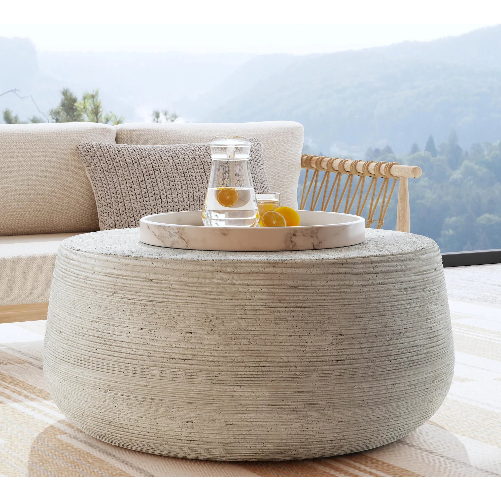 Nellie Round Outdoor Coffee Table by Classic Home in rough light grey. Made from concrete in a modern style.