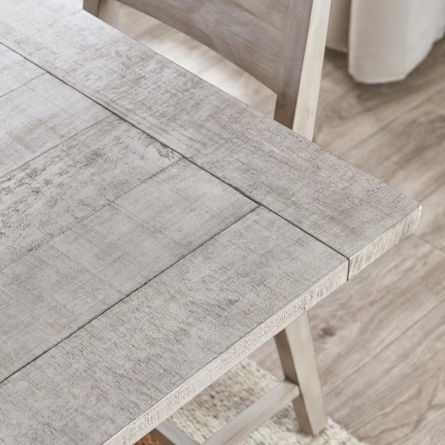 006 SI-2453393 | Closeup | Driftwood Reclaimed Pine Extension Dining Table by Kosas Home in antique ivory and beige. Made from reclaimed pine wood in a transitional style.