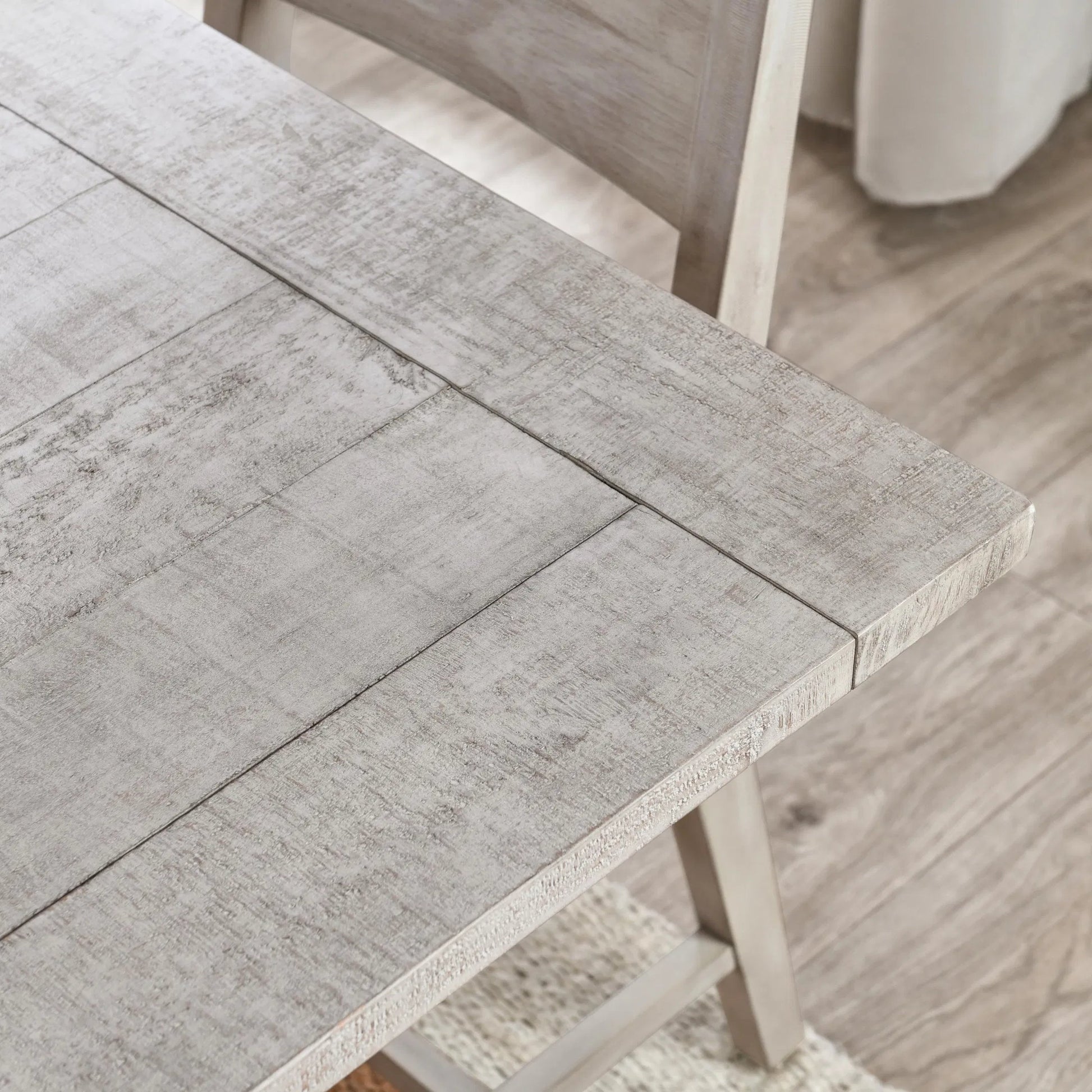 Driftwood Reclaimed Pine Extension Dining Table by Kosas Home in antique ivory and beige. Made from reclaimed pine wood in a transitional style.