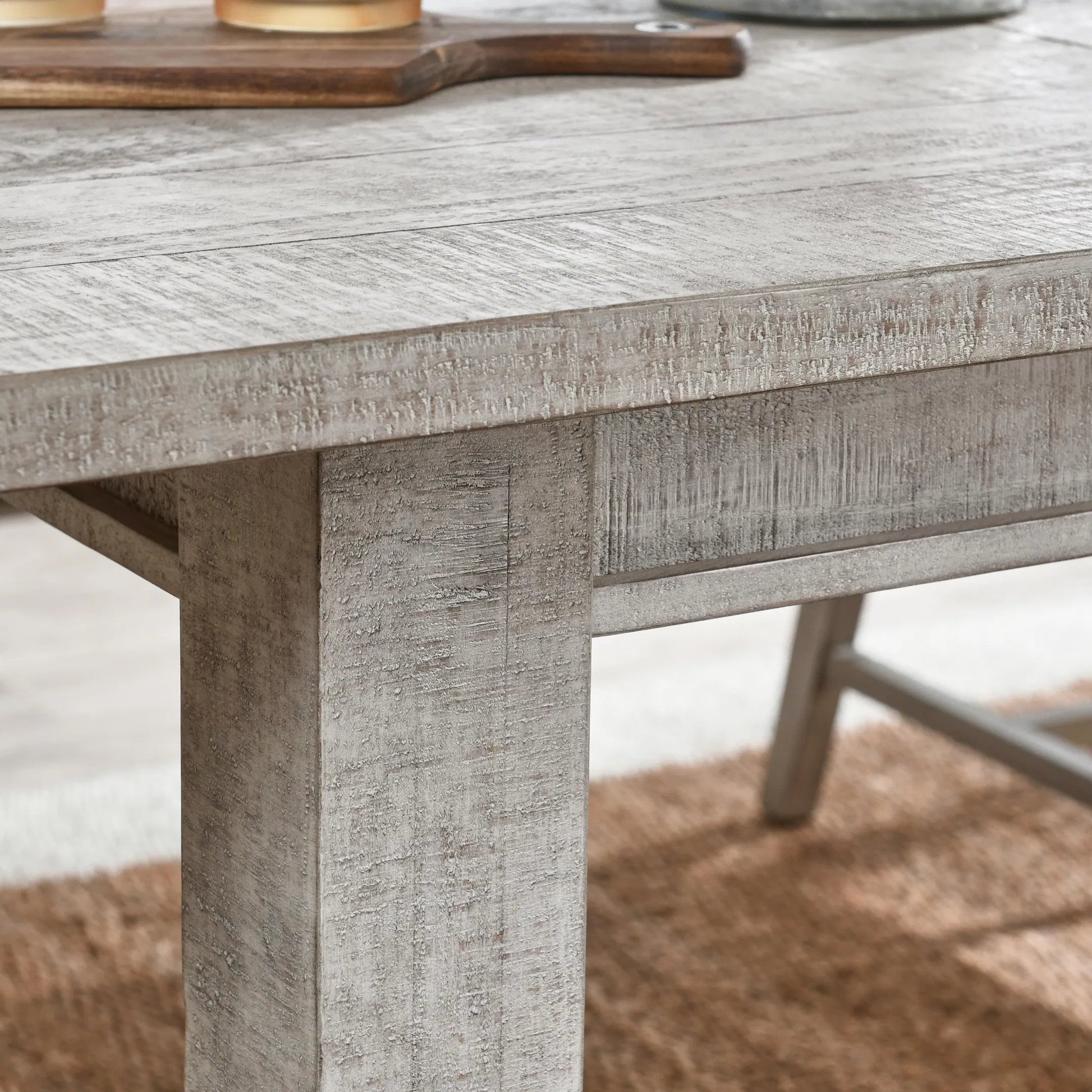 Driftwood Reclaimed Pine Extension Dining Table by Kosas Home in antique ivory and beige. Made from reclaimed pine wood in a transitional style.