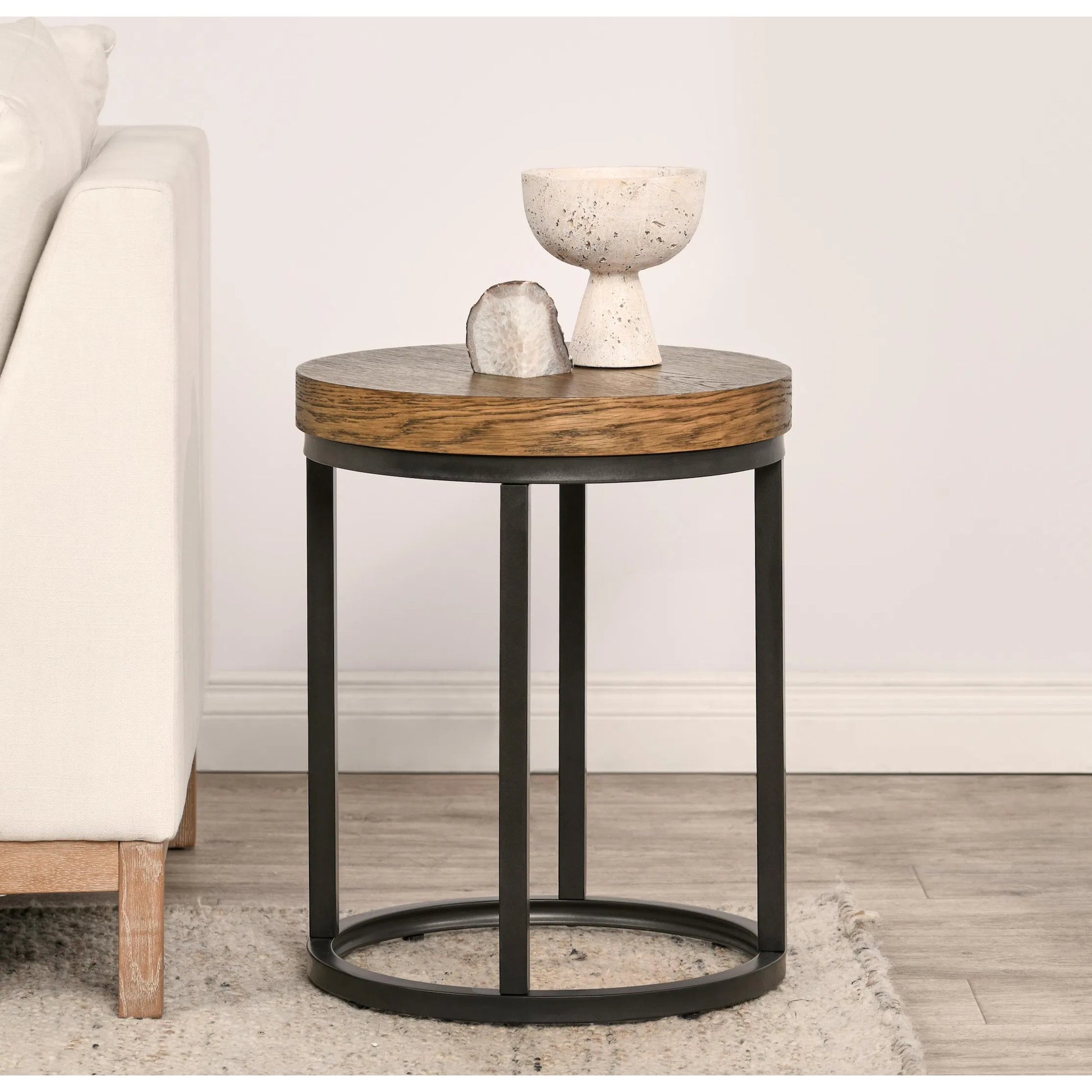 Catta Round Wood End Table by Kosas Home in light brown, black. Made from oak veneer, iron in a unique style.
