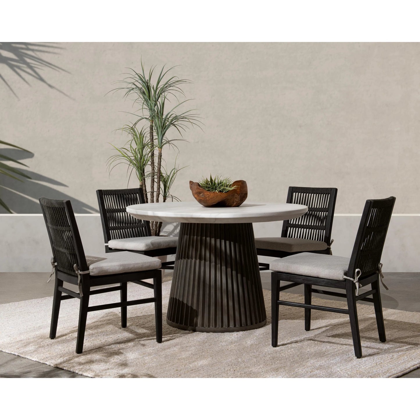 008 SI-2353720 | Lifestyle | Caspia Outdoor Round Dining Table by Classic Home in gray. Made from glass fiber reinforced concrete in a modern style.
