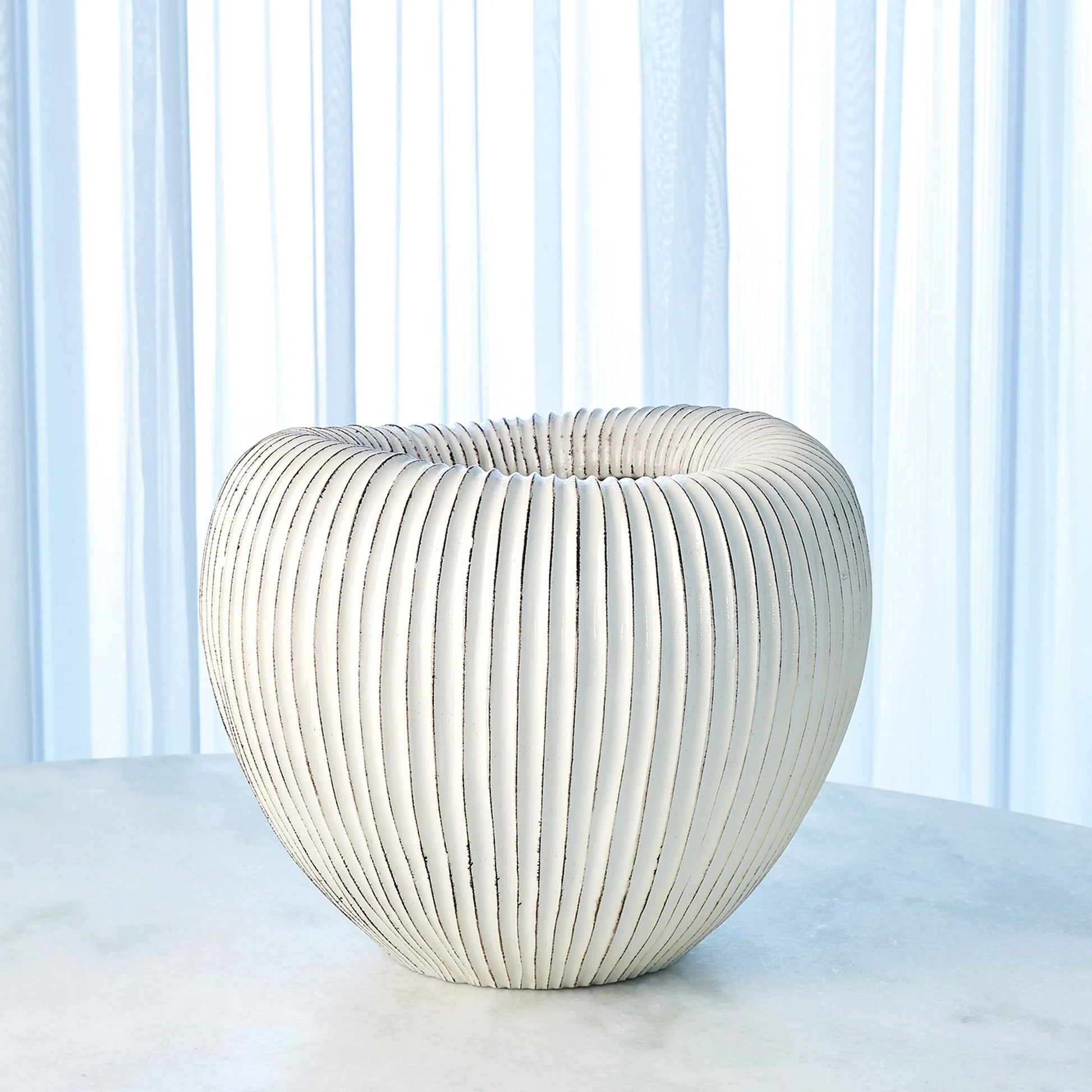 Baleen Cachepot by Global Views in ivory. Made from ceramic in a coastal style.
