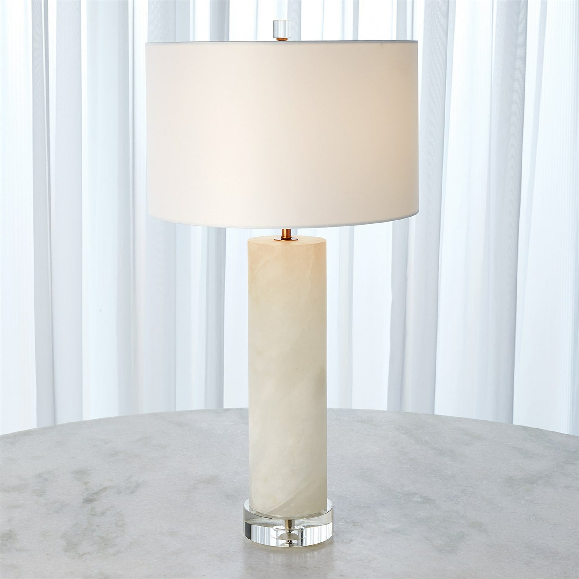 Alabaster Cylinder Table Lamp by Global Views in brass. Made from crystal, metal, alabaster in a coastal style.