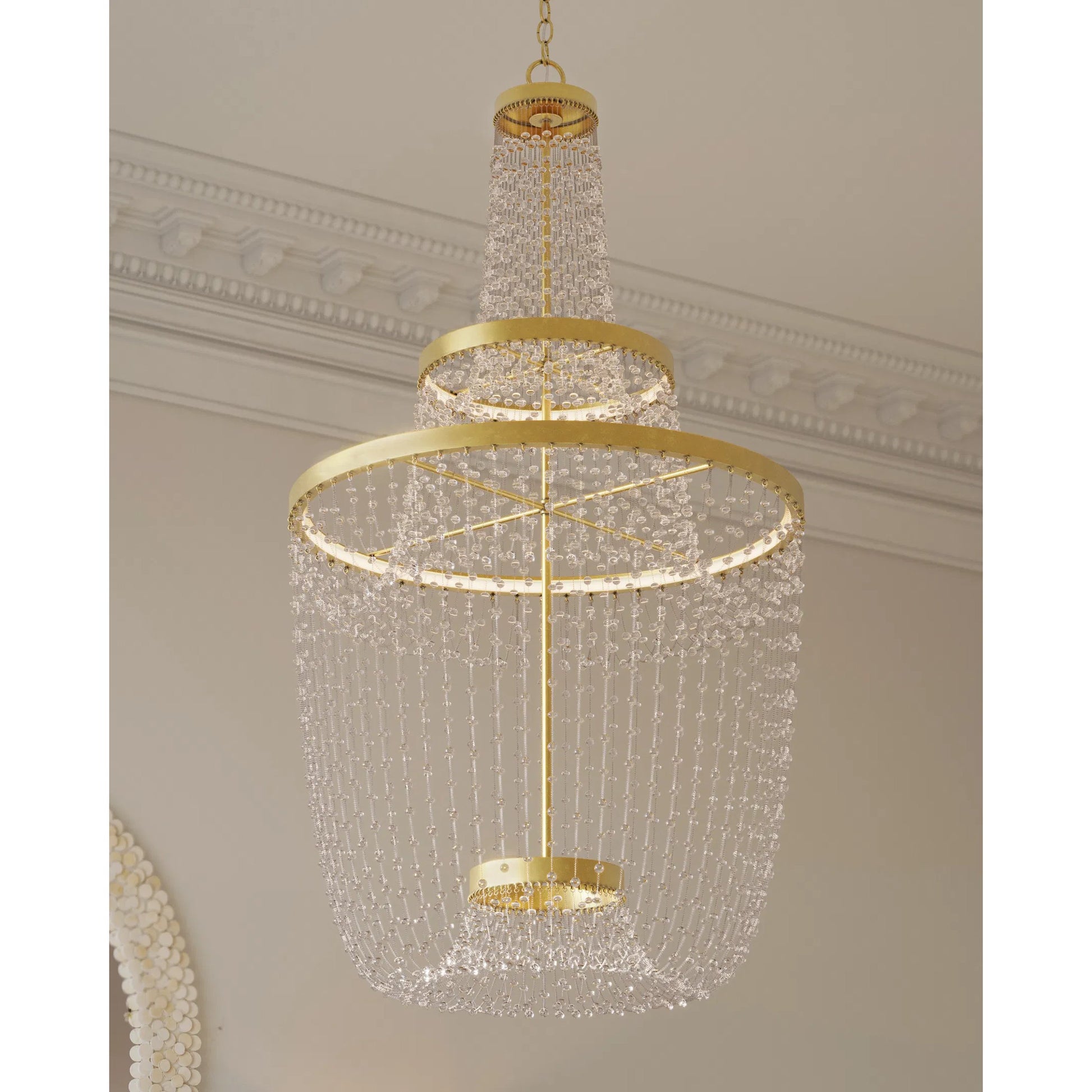 Mademoiselle Chandelier by Currey and Company in contemporary gold leaf, contemporary gold, clear. Made from glass beads, wrought iron in a unique style.