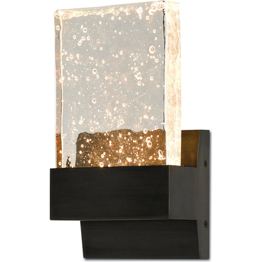 Penzance Wall Sconce by Currey and Company in oil rubbed bronze. Made from metal, seeded glass in a modern style.