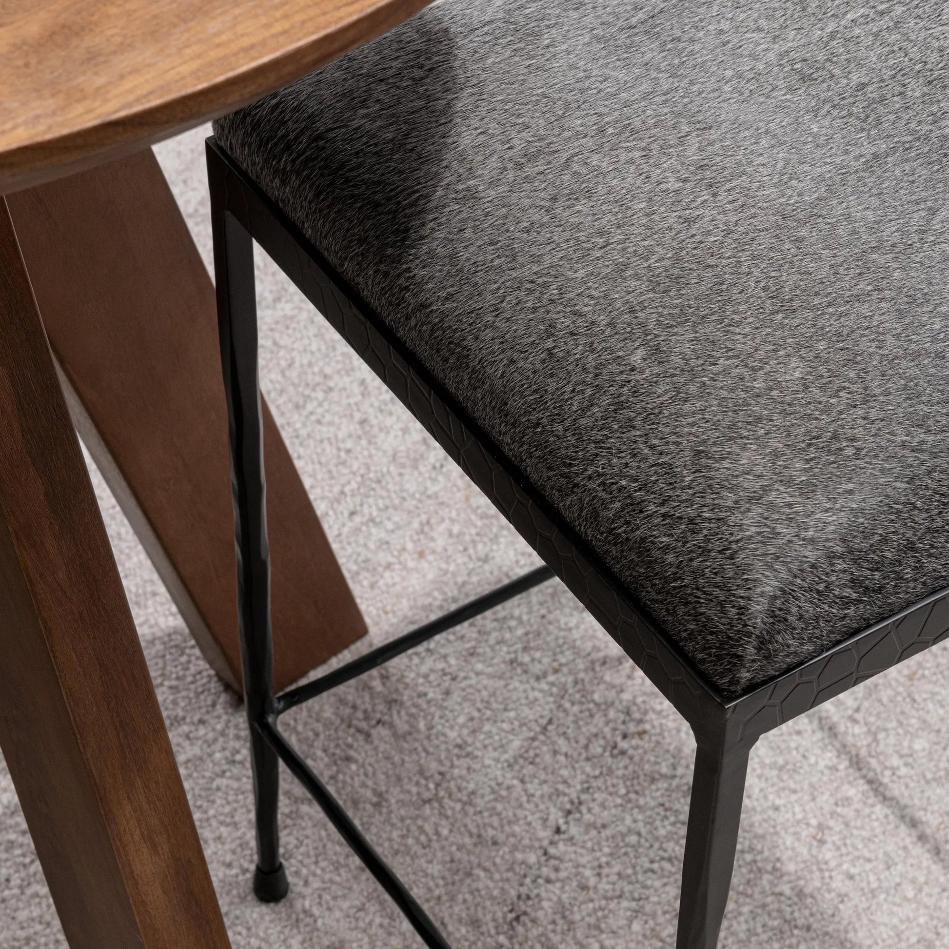 Bose Hide Leather Counter Stool by Classic Home. Made from embossed hammered iron, hair on hide in a modern style.