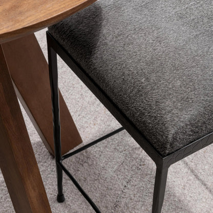 Bose Hide Leather Counter Stool by Classic Home. Made from embossed hammered iron, hair on hide in a modern style.