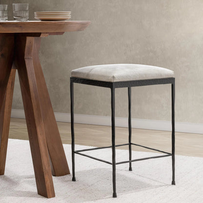 Bose Hide Leather Counter Stool by Classic Home. Made from embossed hammered iron, hair on hide in a modern style.