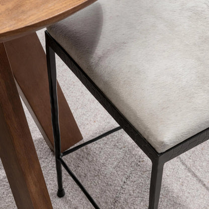 Bose Hide Leather Counter Stool by Classic Home. Made from embossed hammered iron, hair on hide in a modern style.