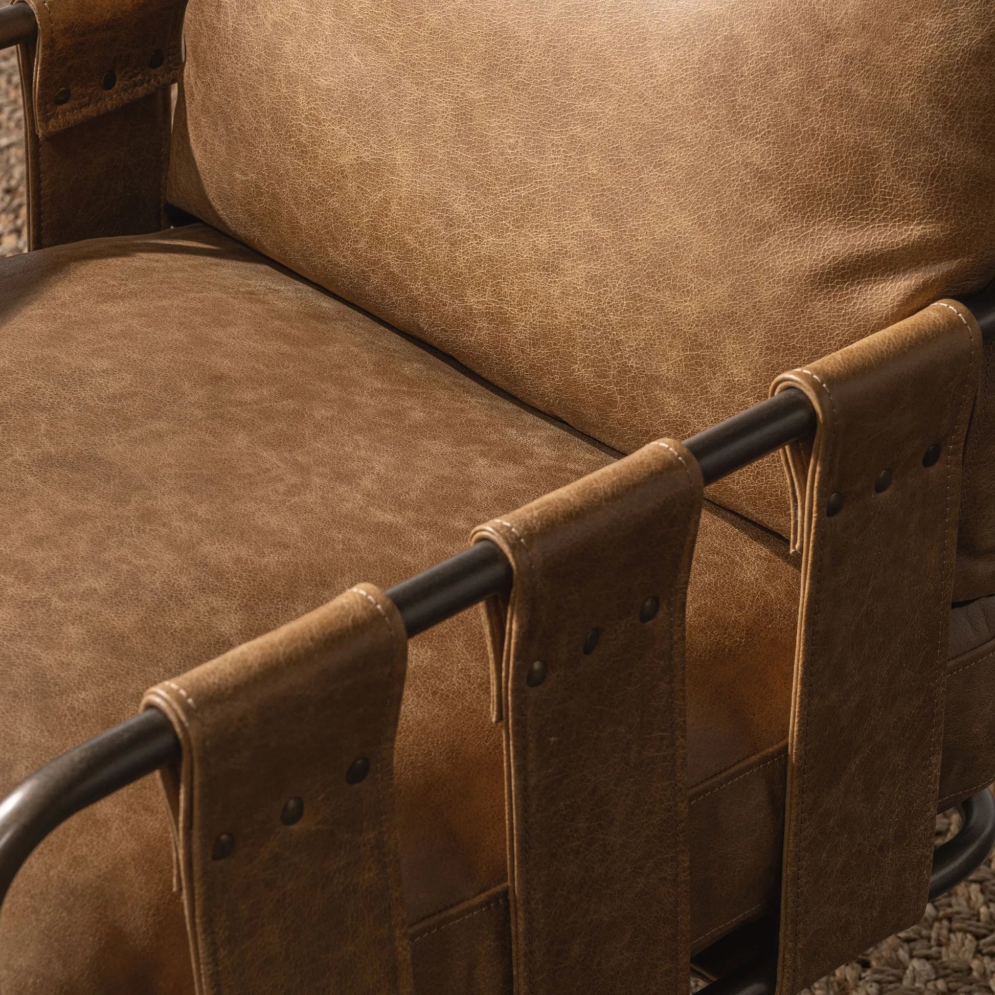 Strapling Leather Dining Chair by Classic Home. Made from top grain leather, iron in a traditional style.