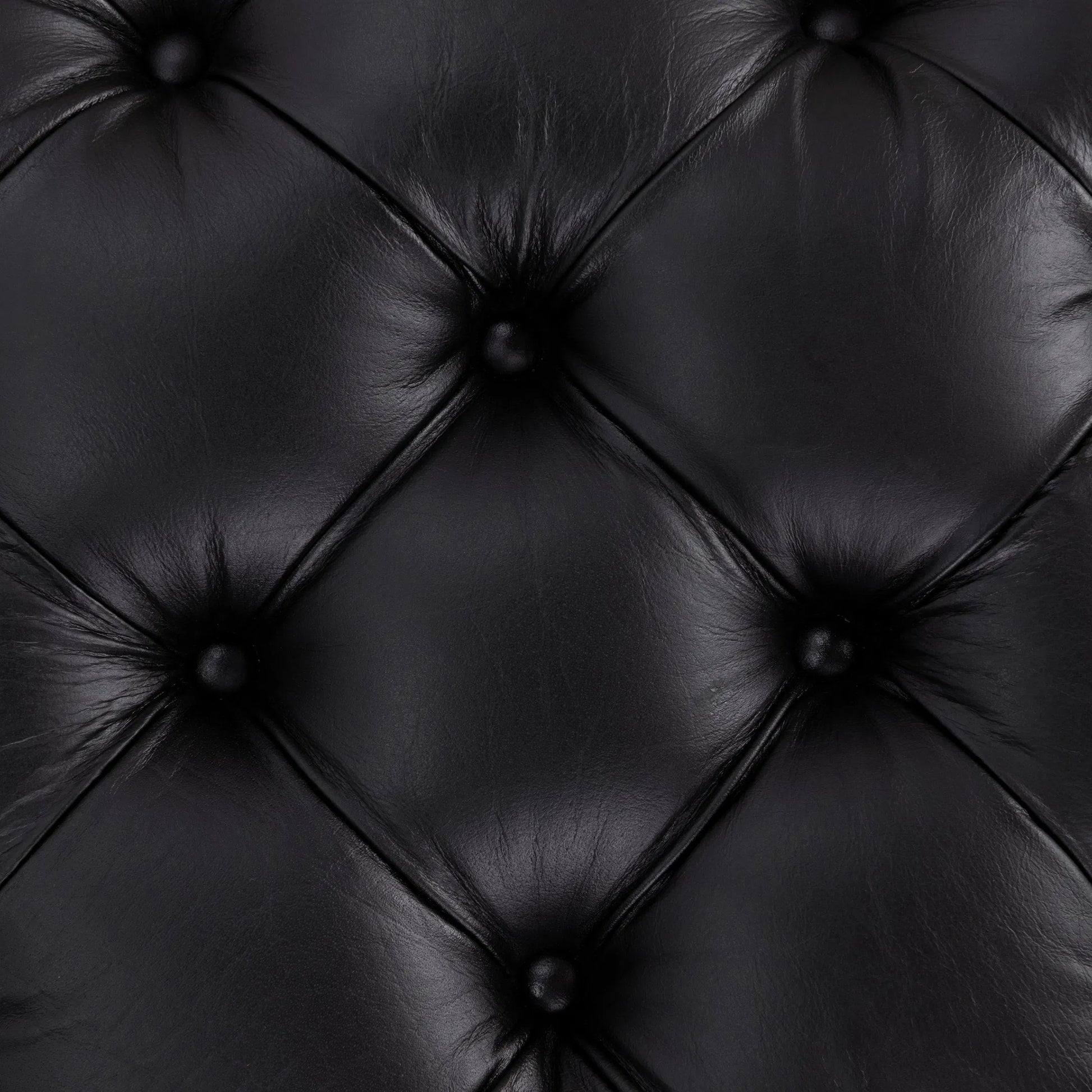 Briar Ottoman by Classic Home in midnight raven. Made from top grain leather in a unique style.