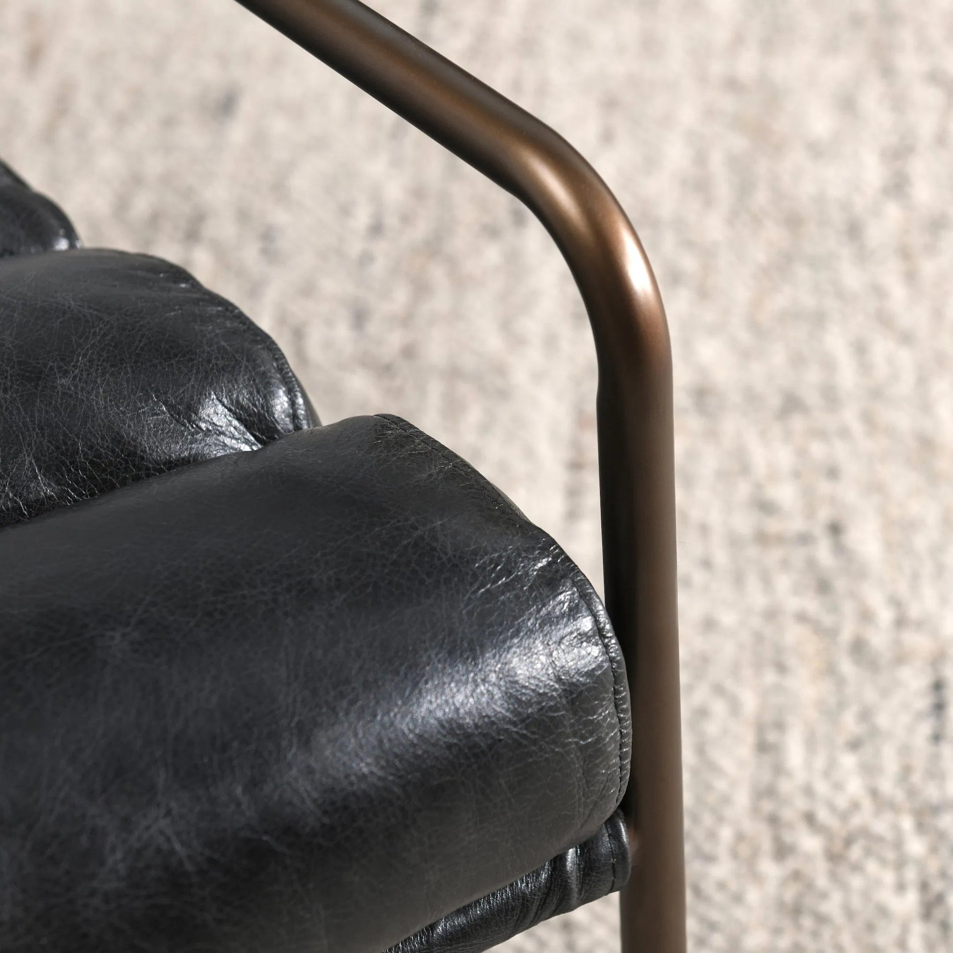 Argo Top Grain Leather Black Accent Chair by Classic Home in black. Made from top grain leather, iron in a modern style.