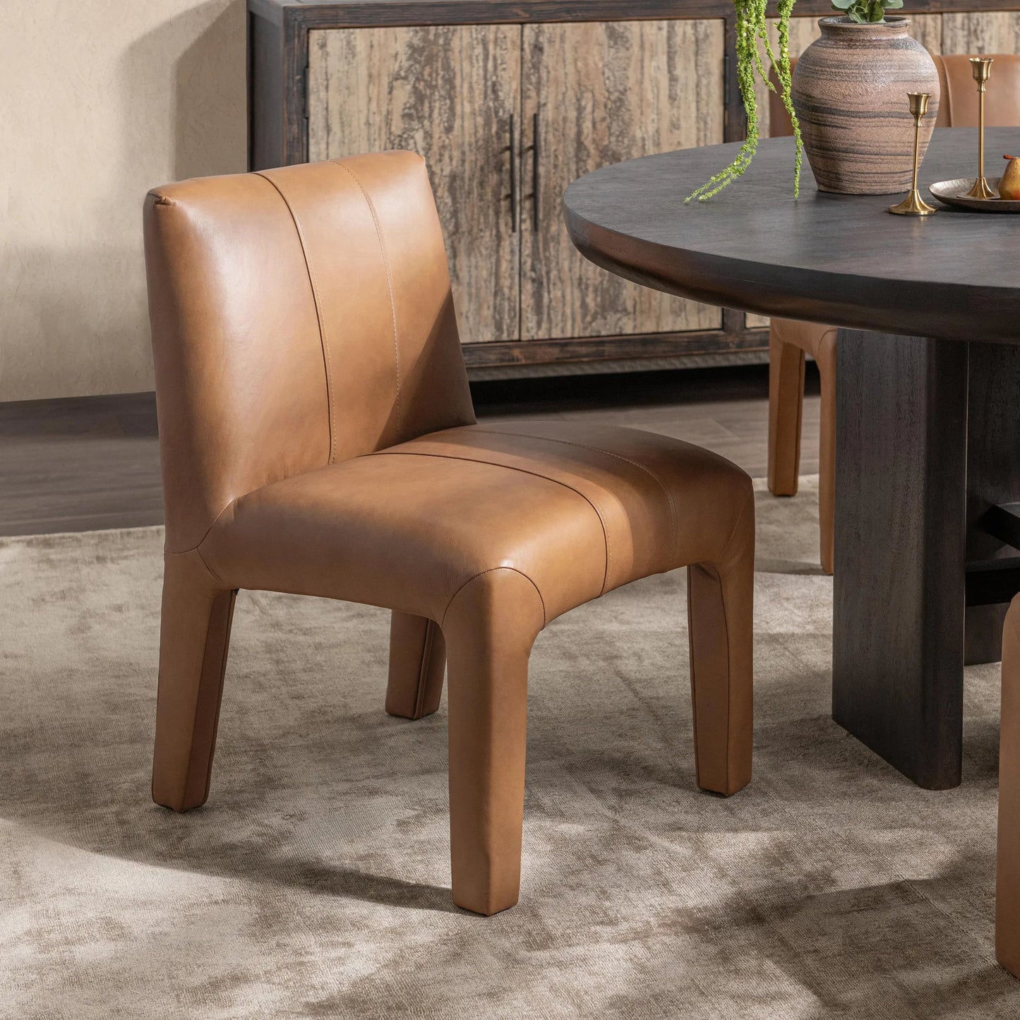 007 SI-2537815 | Lifestyle | Liliana Dining Chair by Classic Home in tan. Made from top grain leather in a unique style.