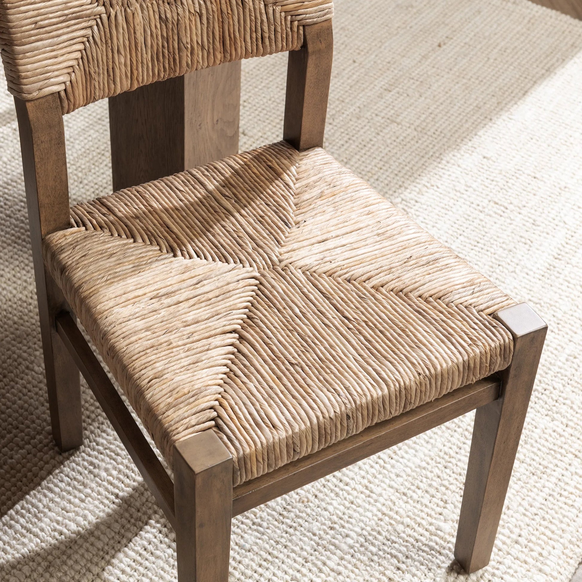 Meryn Dining Chair (Set of 2) by Kosas Home in brown wash. Made from banana bark, mahogany wood in a transitional style.