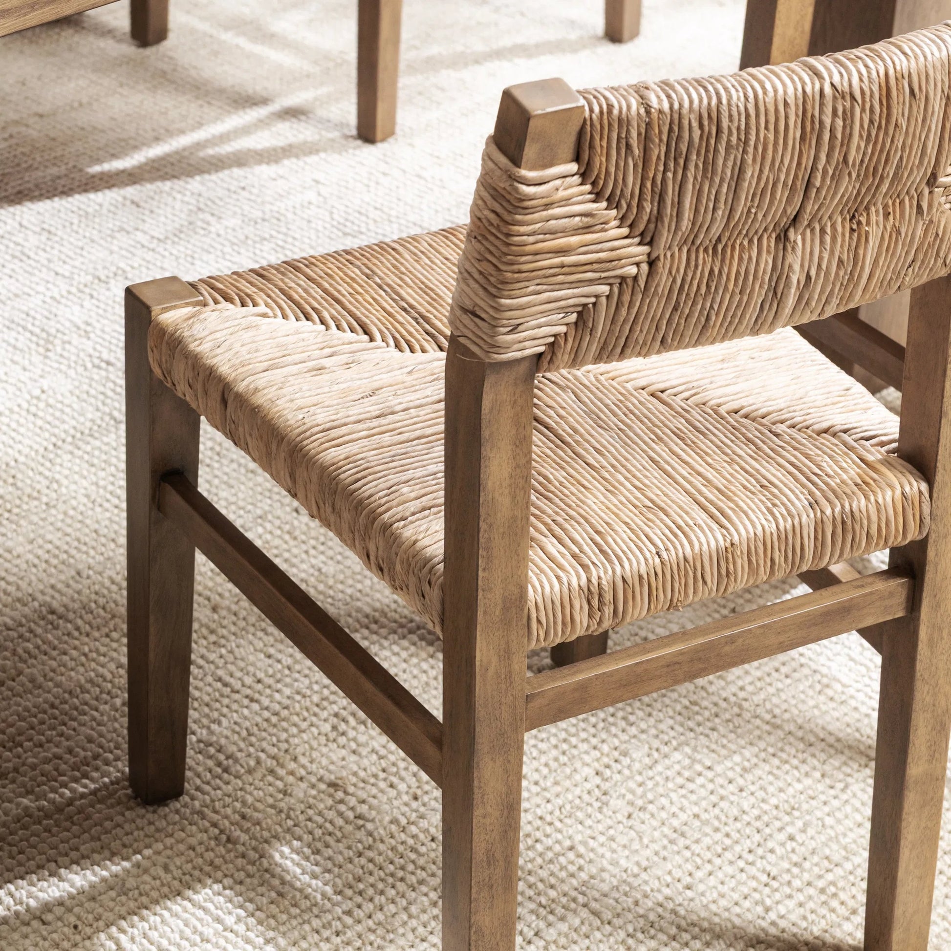 Meryn Dining Chair (Set of 2) by Kosas Home in brown wash. Made from banana bark, mahogany wood in a transitional style.