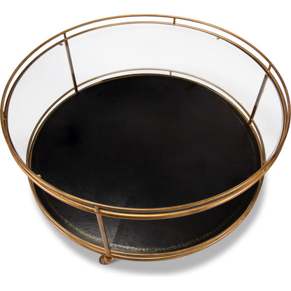 Trolley Cocktail Table by Sarreid Ltd. in gold and top shelf glass lower shelf leathr. Made from glass, metal in a transitional style.