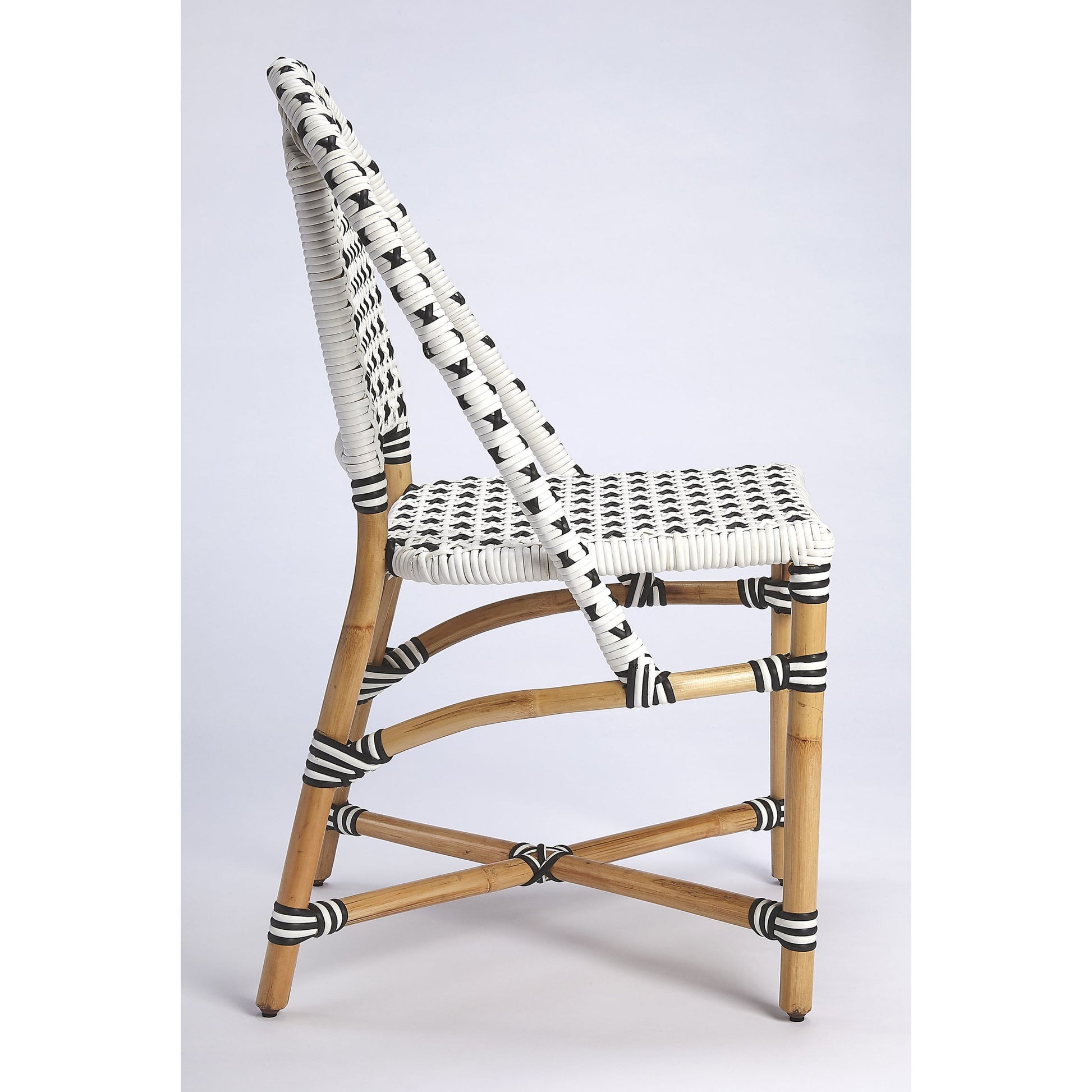 Tenor Dining Chair by Butler Specialty Company in white. Made from 60%-pe plastic weave, 40%-rattan in a coastal style.