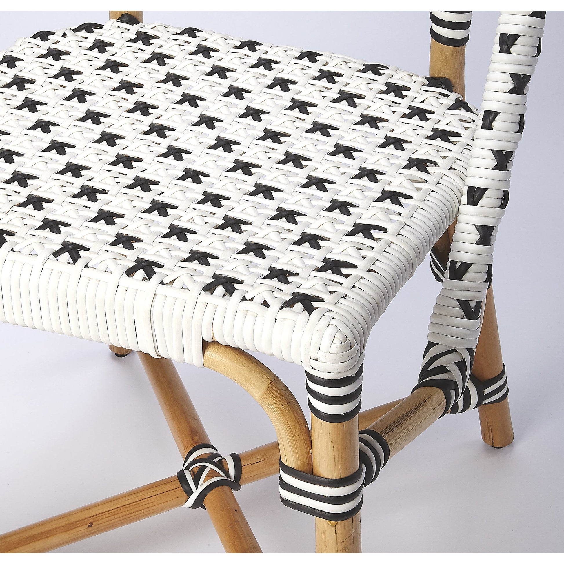 Tenor Dining Chair by Butler Specialty Company in white. Made from 60%-pe plastic weave, 40%-rattan in a coastal style.