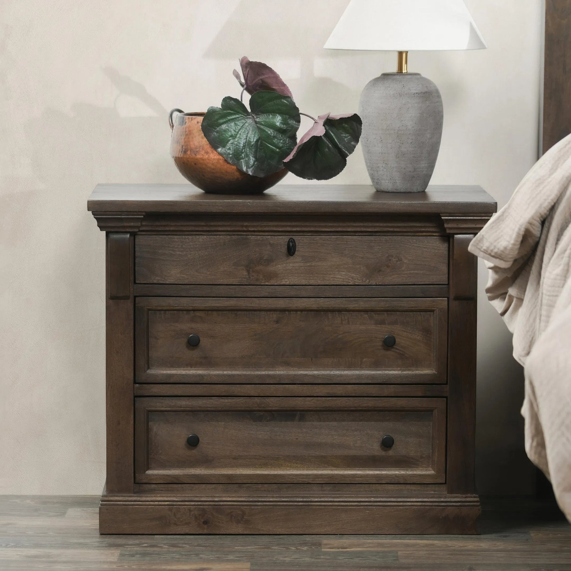 Adelaide Three-Drawer Mango Wood Nightstand by Classic Home in cocoa brown. Made from mango wood in a traditional style.